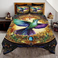 Ornate green hummingbird bedding art with purple wings and a gold jewel frame