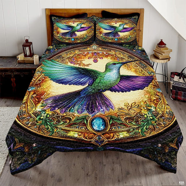 Ornate green hummingbird bedding art with purple wings and a gold jewel frame