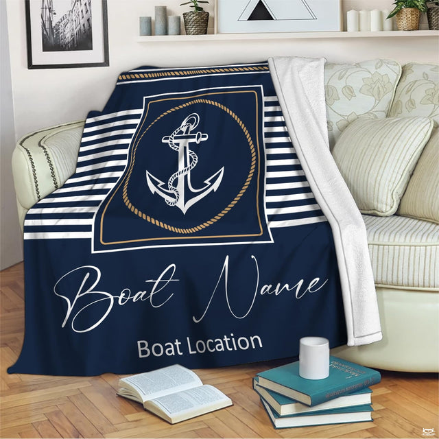 Close up of marine anchor emblem encircled by twisted rope cordage on deep navy coastal bedding.