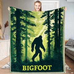 Sasquatch forest silhouette throw blanket showing legendary cryptid walking through sunlit evergreen pines