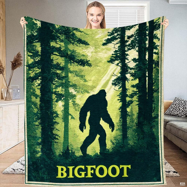 Sasquatch forest silhouette throw blanket showing legendary cryptid walking through sunlit evergreen pines