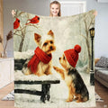 Winter park throw blanket with two Yorkshire Terriers in red scarf and beanie beneath red cardinals on snowy branches