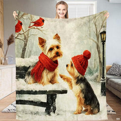 Winter park throw blanket with two Yorkshire Terriers in red scarf and beanie beneath red cardinals on snowy branches