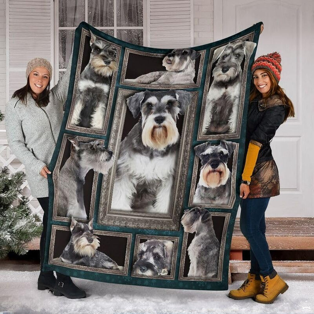 Two models displaying the Miniature Schnauzer blanket outside a snowy winter home entrance.