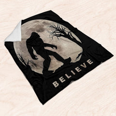 Sasquatch silhouette against thematic accent moon and bare trees styled in rustic folklore bedroom decor