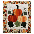 Autumn heirloom pumpkin trio throw blanket featuring ribbed orange gourds and foliage garland border on ivory