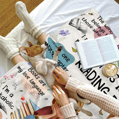 Bedroom interior showcasing the bookish sayings throw blanket displayed over an accent lounge armchair.