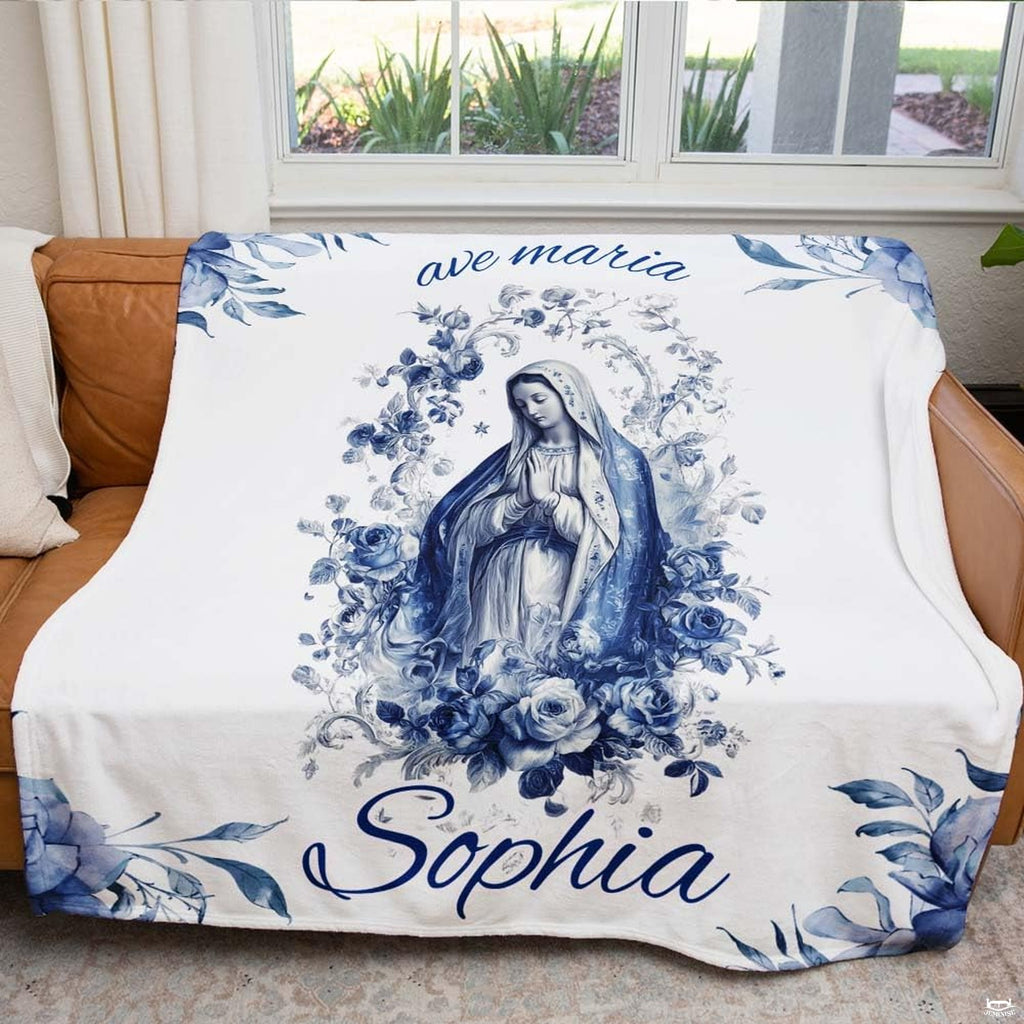 Spiritual religious textile styled draped across a tan leather living room couch near a sunny window.