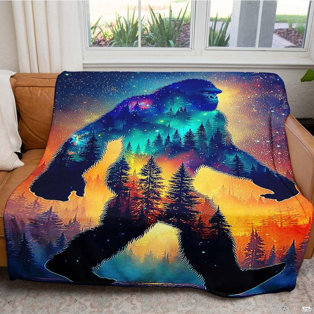 Close-up of golden sunset horizon and pine forest silhouette inside a mystical Sasquatch graphic.