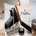 Ice hockey skate wooden stick and puck blanket held upright