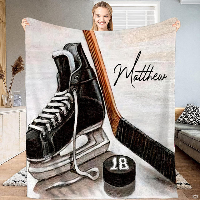 Ice hockey skate wooden stick and puck blanket held upright