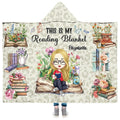 Frontal view of chibi reader girl surrounded by wildflowers and book stacks on blanket.