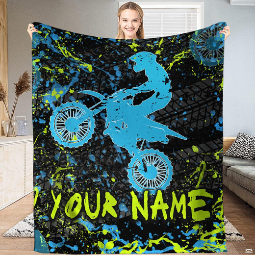 Airborne motocross dirt bike rider silhouette with neon splatters and tire tracks, view 1.