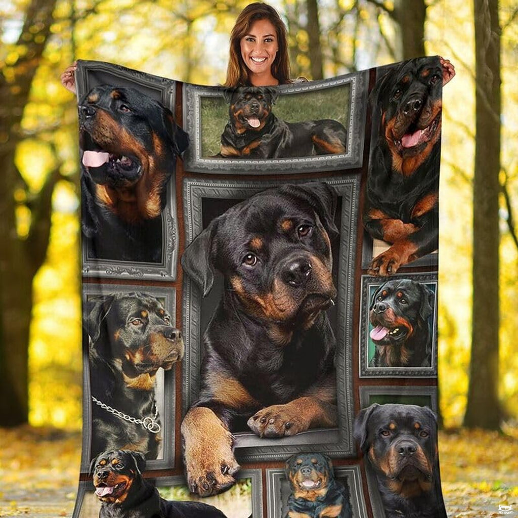 Outdoor view of a model holding up the full Rottweiler gallery throw blanket.
