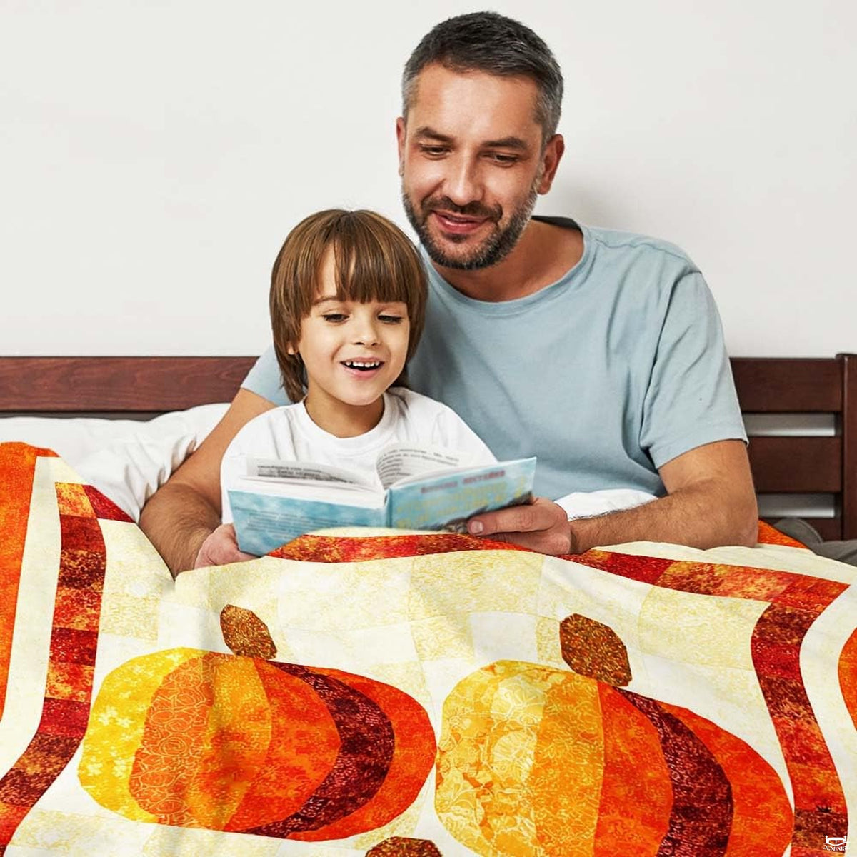 Close-up perspective of patchwork pumpkin motifs and maple leaves on throw blanket