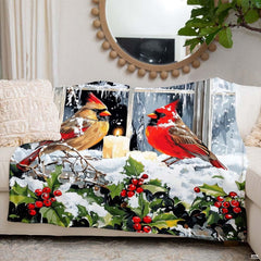 Lifestyle setting displaying the winter bird throw blanket neatly folded on an armchair.