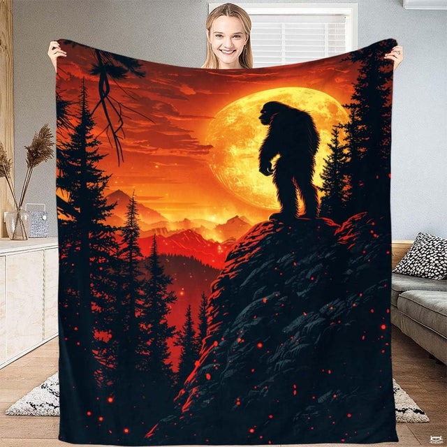 Bigfoot cliff harvest moon throw blanket featuring Sasquatch silhouette on rocky ridge under lunar sky
