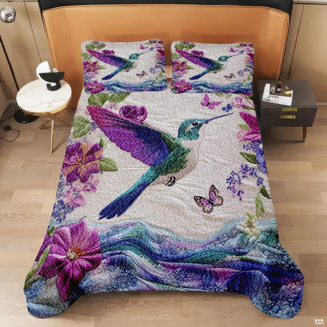 Overhead view of purple butterfly and hummingbird bedding artwork