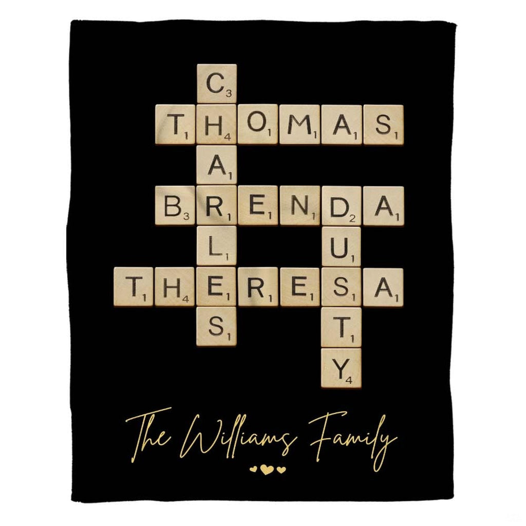 Full flat overhead view showing the complete interlocking letter tiles crossword puzzle blanket design on black.