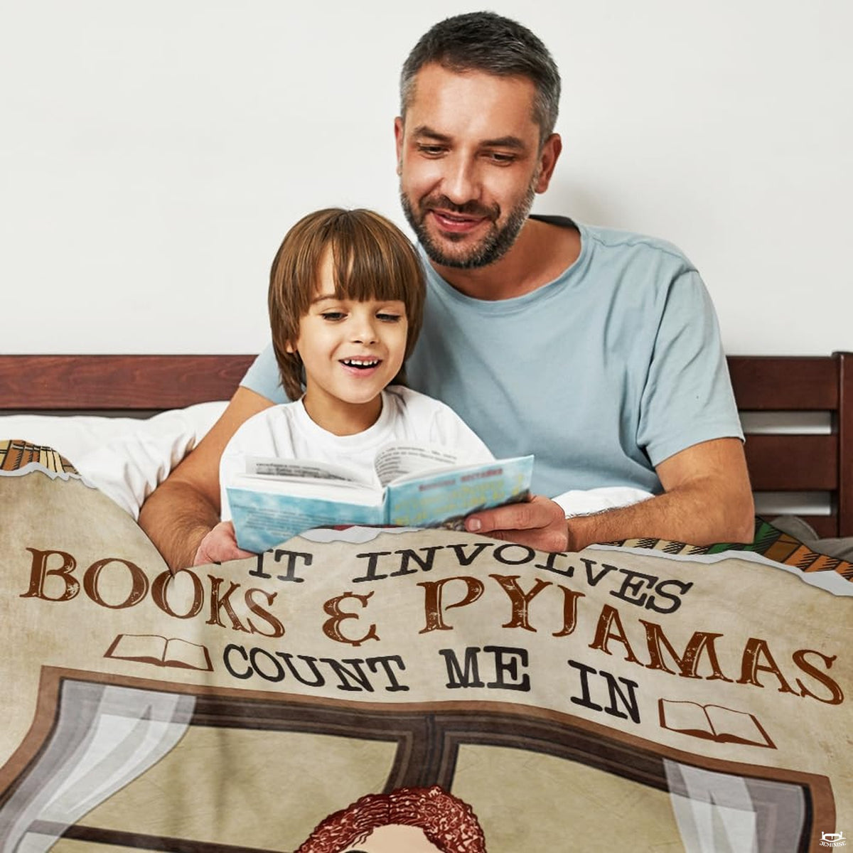 Bedroom setting featuring literary throw blanket spread across a bed beside books.