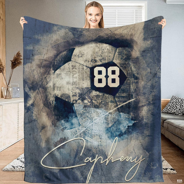 Vintage soccer blanket featuring watercolor soccer ball with antique newsprint textures in slate blue.