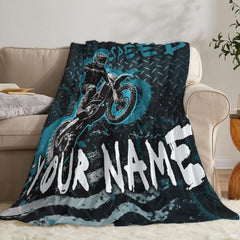 Side perspective of stylish dirt bike bedroom decor featuring airborne rider visual on bed spread.