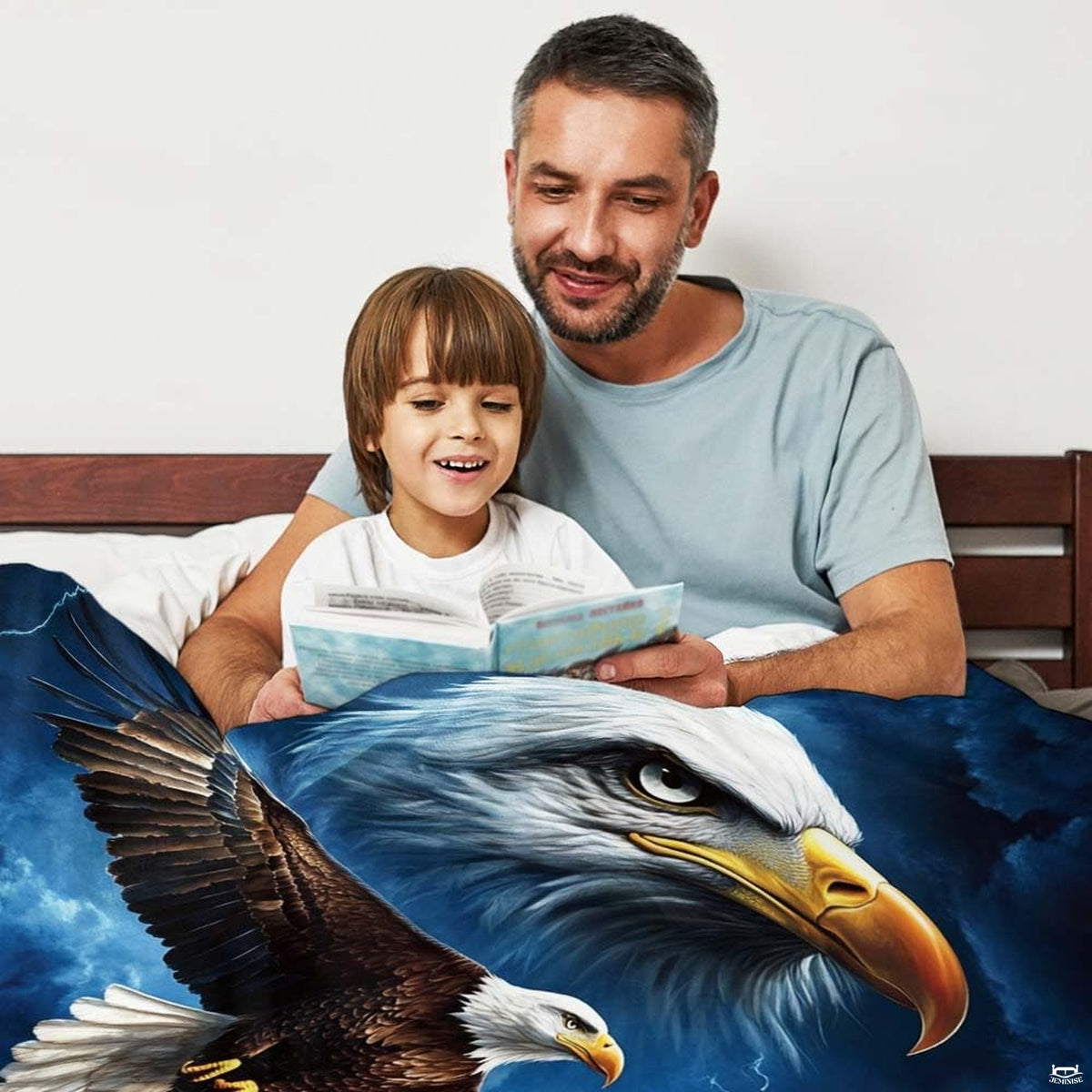 Bald eagle in flight over rugged alpine summits amidst deep navy clouds on bedding.