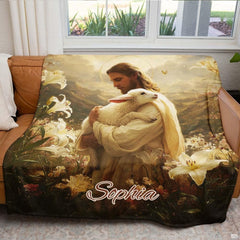 Good Shepherd Jesus blanket displayed across a brown leather armchair near a sunny window.