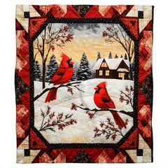 Close-up of crimson cardinals on snow-dusted evergreen branches in rustic cabin bedding decor.