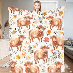 Closeup of adorable illustrated highland cow face with curved horns on bedroom bedding.