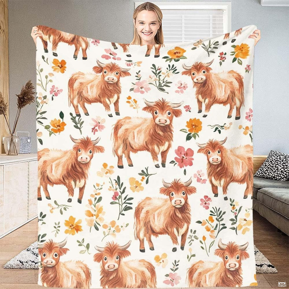 Closeup of adorable illustrated highland cow face with curved horns on bedroom bedding.