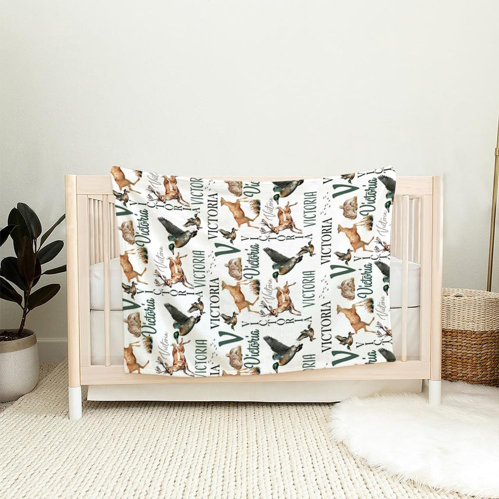 Woodland wildlife print piece draped gracefully over the wooden railing of a light timber nursery crib.