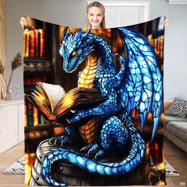 Blue sapphire dragon throw blanket featuring glowing winged dragon reading an illuminated spellbook.