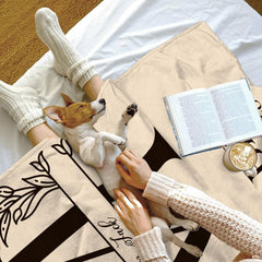 Laurel initial throw blanket displayed as a decorative accent on an armchair