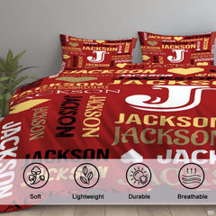 Full overhead view of red monogram typography bedding spread across a contemporary bedroom bed arrangement
