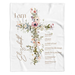 Flat lay view of botanical wildflower cross design with scripture verses on off-white blanket.
