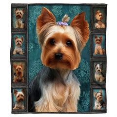 Close-up of the painted Yorkshire Terrier face displaying lavender topknot bow, soulful eyes, and golden fur on a blanket
