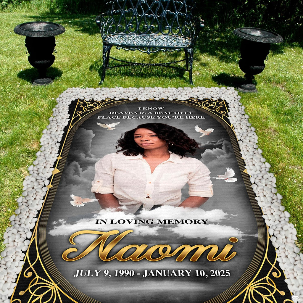 Detailed perspective of soaring white doves and golden scrollwork on dark tribute drape