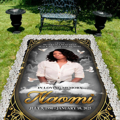 Detailed perspective of soaring white doves and golden scrollwork on dark tribute drape