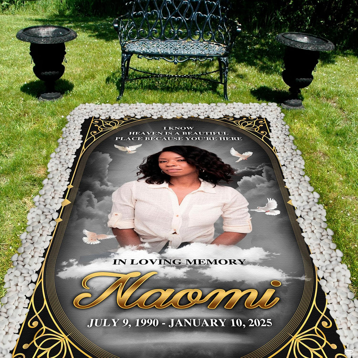 Detailed perspective of soaring white doves and golden scrollwork on dark tribute drape