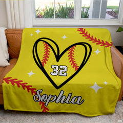 Living room staging displaying softball heart throw blanket styled across a modern sofa.