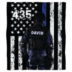 Tactical officer blue line flag graphic blanket draped across sofa