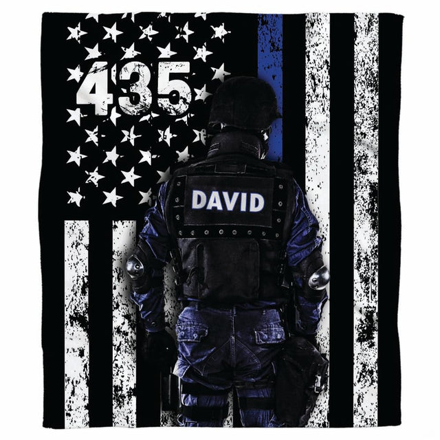 Tactical officer blue line flag graphic blanket draped across sofa