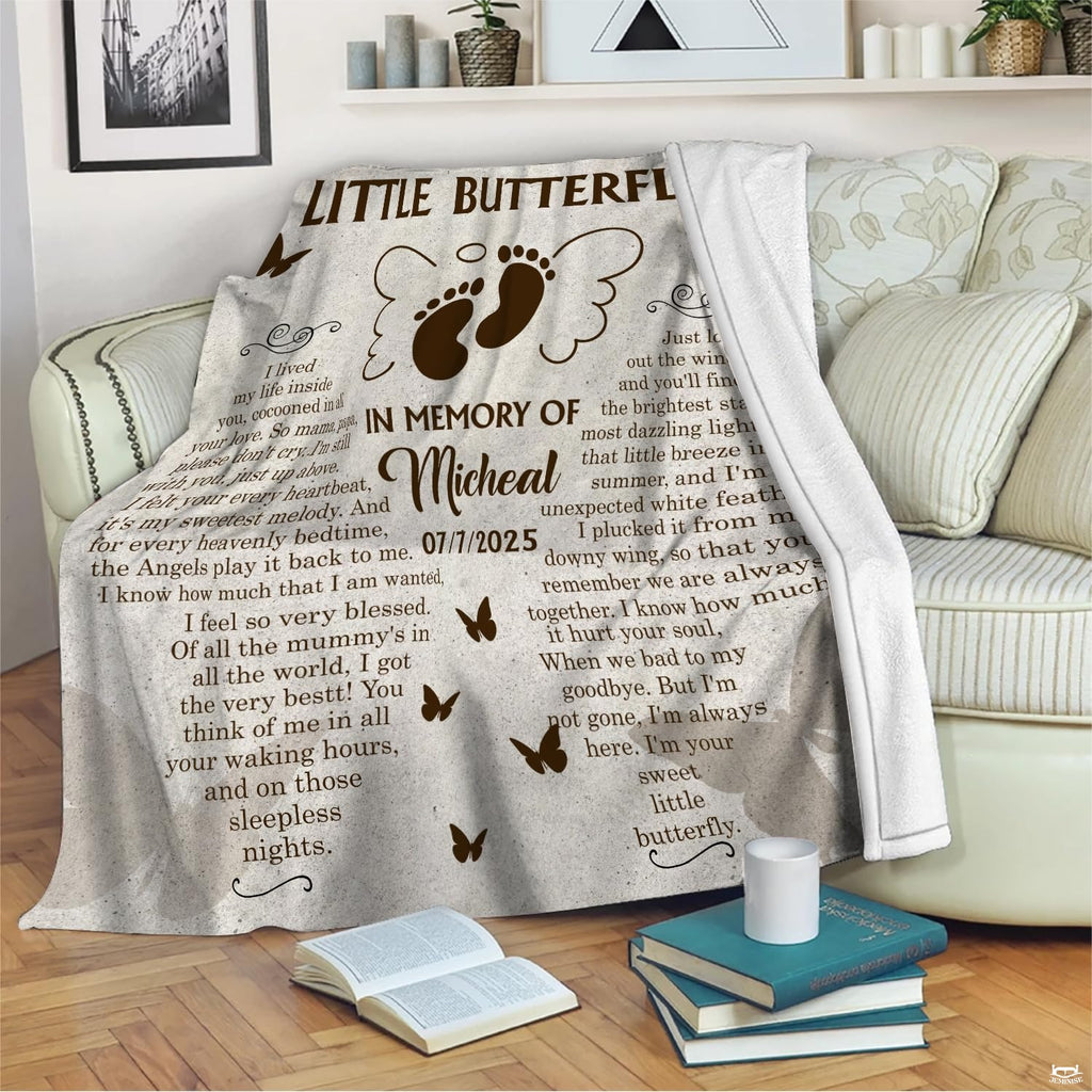 Memorial butterfly blanket draped across armchair beside table with coffee mug.